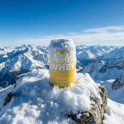 Can of cryotein Whey protein powder on a snowy mountain peak with a breathtaking view of snow-capped mountains.