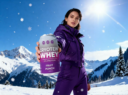 Person in purple ski outfit holding a cryotein Whey protein supplement can in a snowy mountain setting