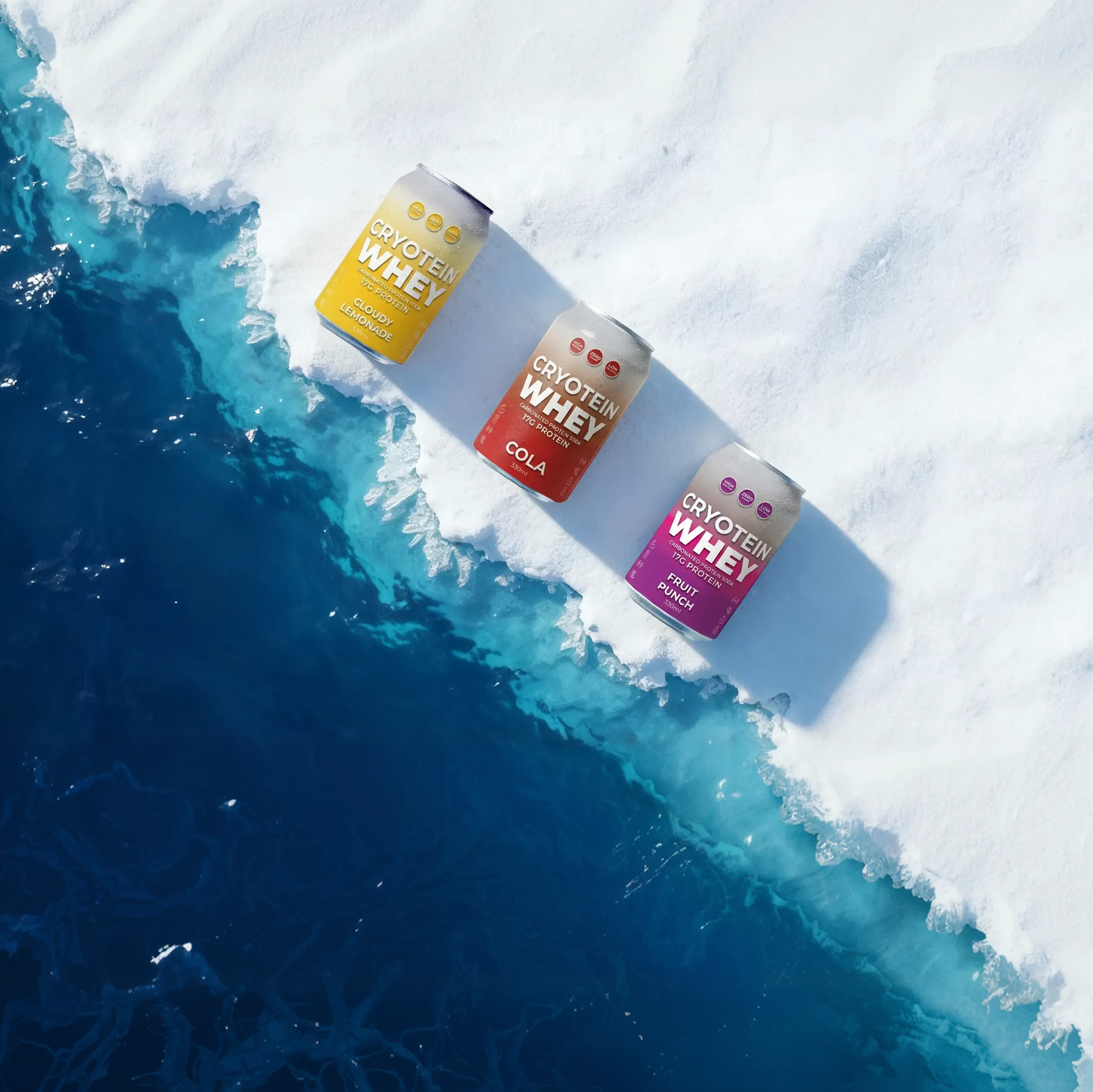 Three cans of Cryotek Whey protein powder on a snowy surface with blue water.